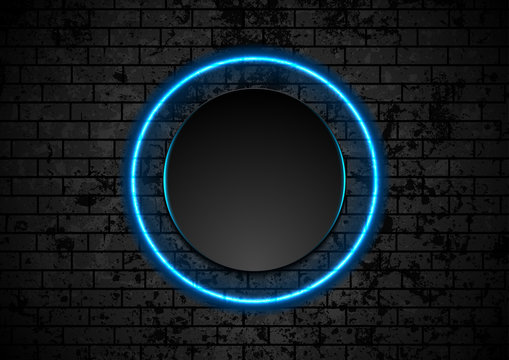 Blue neon circle on grunge brick wall background