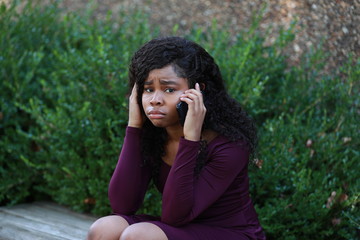 Crying black woman speaking on phone