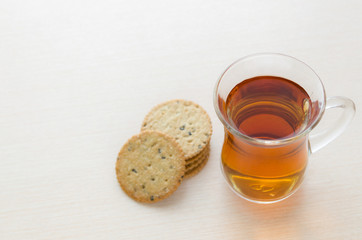 Tea cup with menbrillo cookies on bright silver background