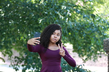 Fototapeta premium Pretty black woman grimacing and gesturing for selfie