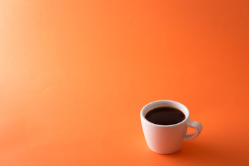 cup of coffee on orange background