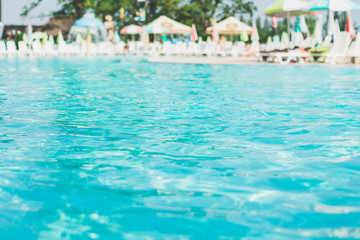 Fototapeta na wymiar Water swimming pool. pool with blue water. Background of clean blue rippled water in a hotel swimming pool