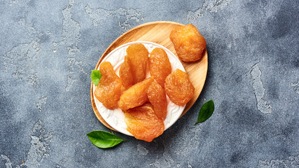 Candied sliced pear. Dried fruits on gray background. Top view.