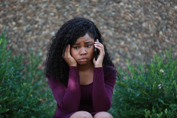 African American woman having uneasy phone conversation