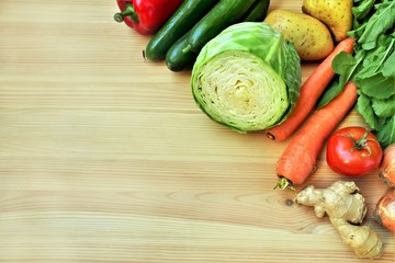 Raw vegetables on a wooden table, top view, copy space.