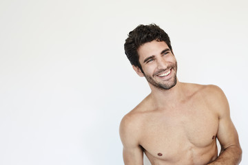 Fototapeta premium Hunky topless guy smiling in studio