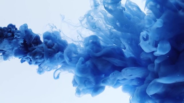 Inky background or backdrop with smoke or ink effects. Blue colour ink drop in water.