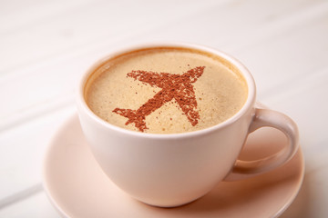Cup of coffee with airplane on foam Morning coffee