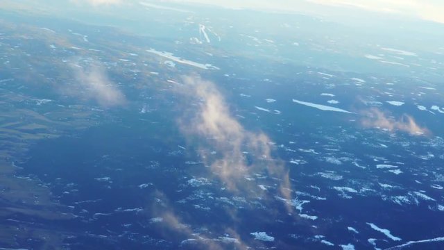 Plane soaring through cloud, aerial view of city and ocean slow motion video