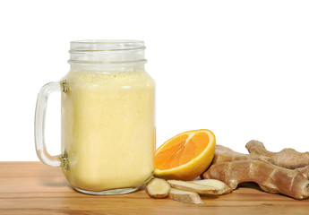 Tonifiyng smoothie in a mason jar with ingridientes on a wooden 