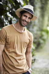 Good looking guy in hat smiling to camera