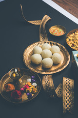 Raksha bandhan Festival : conceptual Rakhi made using plate full of Rasgulla sweet with band. A traditional Indian wrist band which is a symbol of love between Brothers and Sisters