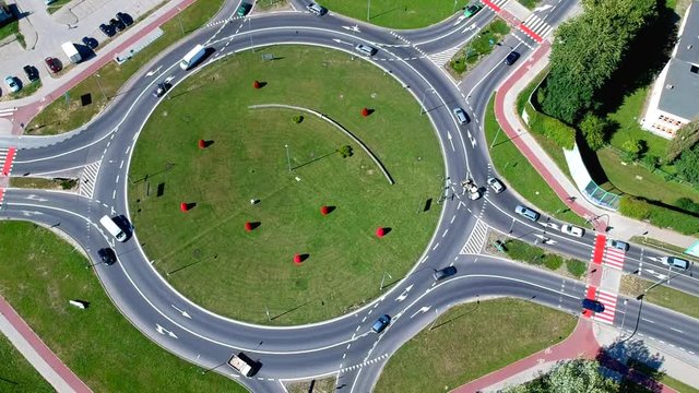Aerial footage, roundabout intersection in city.