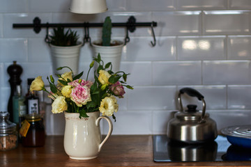Kitchen room interior decorated with spring  flowers in vase on the table.