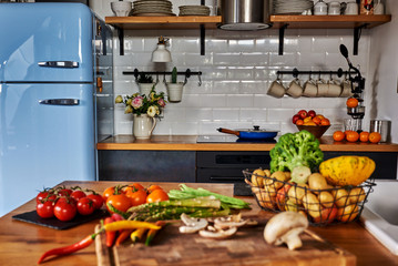 Vintage style kitchen and vegetables on the table.