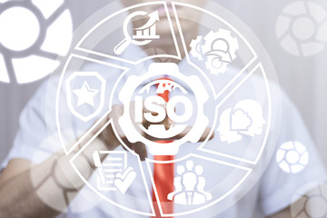 Businessman clicks a gear with planet earth and iso word button on a virtual panel. ISO Certification Quality Global Standards. Management Business Certified concept.