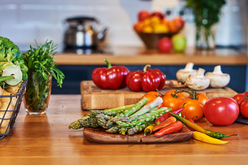 Fresh vegetables for salad on a kitchen table.
