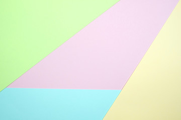 Obraz premium Fashionable pastel colored paper flat lay top view, geometric background texture, pink, purple, yellow, beige, green and blue.