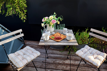 A tasty food on an outdoor table. Lunch on a terrace. Jamon with croissants on summer terrace in the garden.