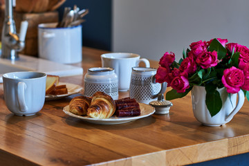 Rural breakfast with cup of coffee, croissant, homemade cheese and  jamon on rustic  wooden table.