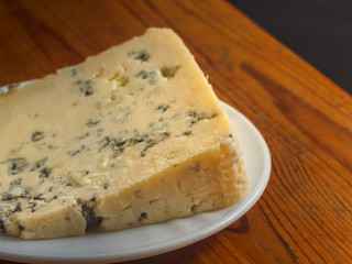 White plate with cheese on the table