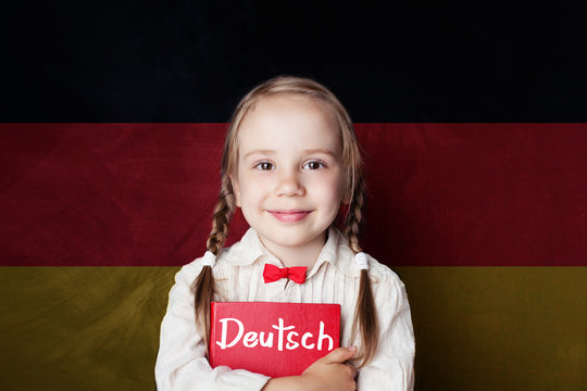Learning german language concept with happy child girl and german flag background