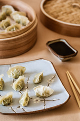Asian gyoza, dumplings snack, chopsticks, steamer