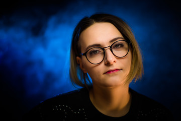Fototapeta na wymiar portrait emotional young girl on blue background