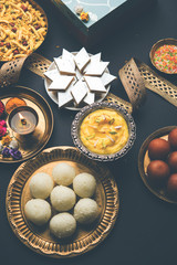 Raksha bandhan greetings : Sweet food like Gulab Jamun, Rasgulla, Shrikhand, Bundi Laddu, Kaju Katli and farsan with Pooja thali for Rakhi Festival Celebration