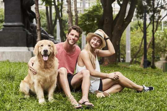 Pretty couple and pet dog in park, brazil