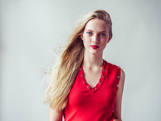 Red dress woman with blonde long hair and beauty red lipstick