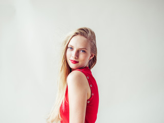 Fototapeta premium Beautiful blonde woman with long blonde hair and red lips