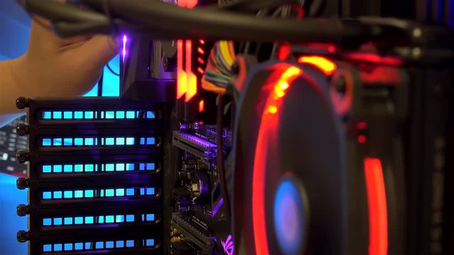 User's hand connecting the cable to the modern PC during operation.