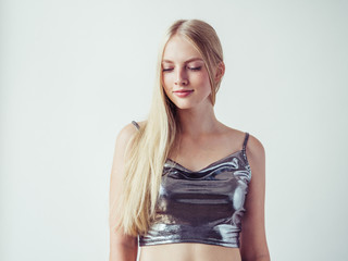 Naklejka premium Blonde long hair woman girl in silver dress over white background