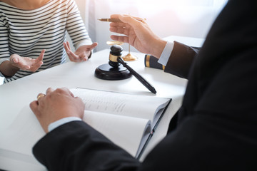 Legal counsel presents to the client a signed contract with gavel and legal law. justice and lawyer concept.