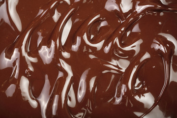 Melted chocolate swirl as a background closeup