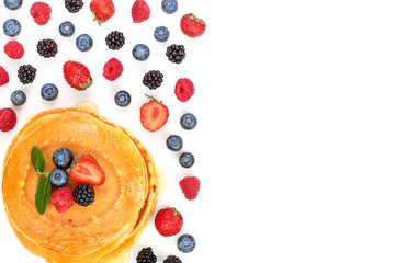 Pancakes stack with different berries isolated on white background with copy space for your text. Top view. Flat lay