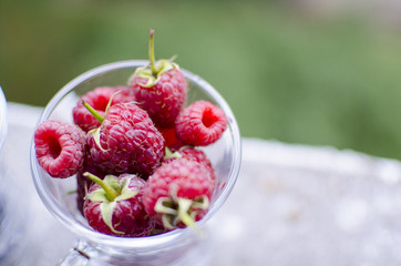 A glass of sweet red raspberries