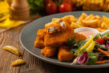 Fish sticks with fries and salad.