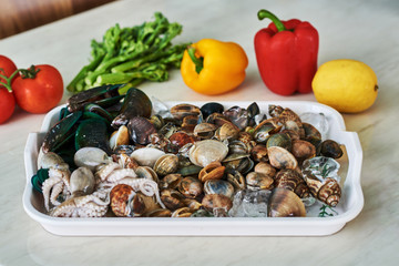Fresh raw seafood and vegetables in the kitchen