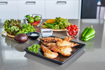 Grilled king size prawns on on kitchen table.
