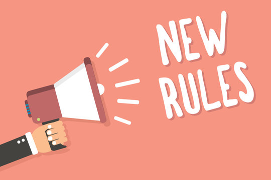 Text sign showing New Rules. Conceptual photo A state of changing an iplemented policy for better upgrade Man holding megaphone loudspeaker pink background message speaking loud.