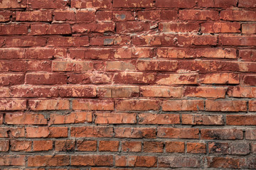 Red  old brick wall of an building, background texture of a brick