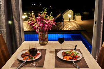 Romantic dinner in a villa overlooking the pool.