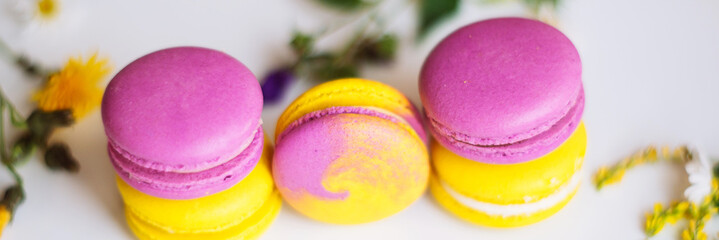 Symbol heart of flowers and macaroons on the light background. Top view. Text I love you