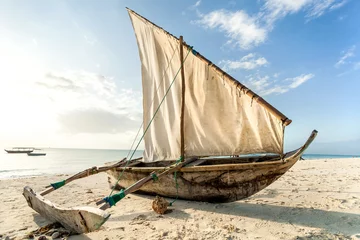 Papier Peint photo Zanzibar A Dhow boat on the beach. Sailing boat on the shore.