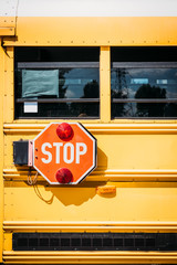 side view of school bus with stop sign