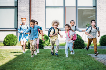group of adorable pupils runing by school garden © LIGHTFIELD STUDIOS