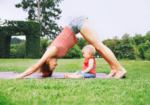 Woman Doing Yoga With Baby In Nature