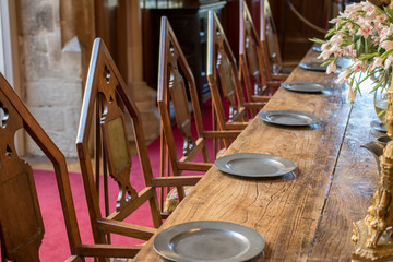 Medieval dining table and chairs. Mediaeval fraternal banqueting hall.